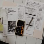 Minimal flat lay of budget planner, coins, calculator and grocery list for frugal personal finance tips, horizontal 1200x600 banner